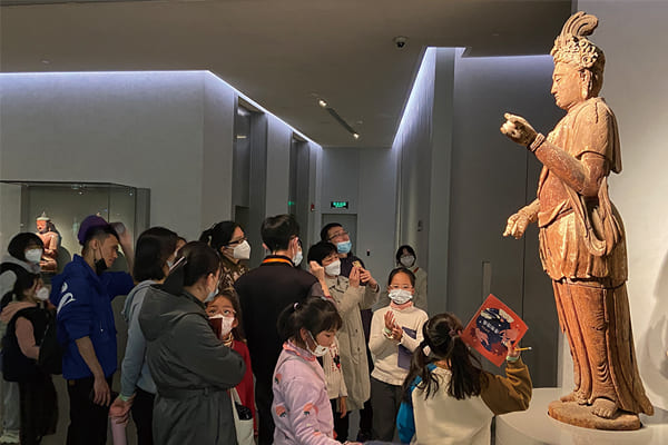 圖一：親子家庭共同探索六樓展廳，在展品前聽志愿者講解。