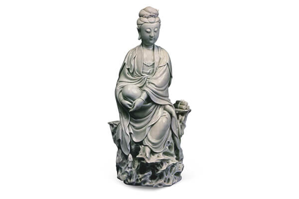 明末+德化窯．白瓷觀音半跏坐像+此尊造像面容慈悲，法相莊嚴，表面施白釉，釉色潤澤如玉，+是德化窯的代表作品。（圖三）+圖片來源：《世界陶磁全集15清》，頁120，圖129。